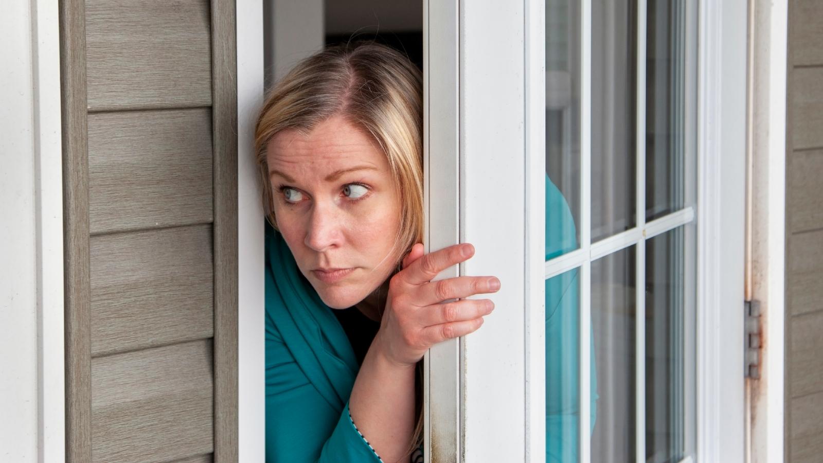 woman looking out a door