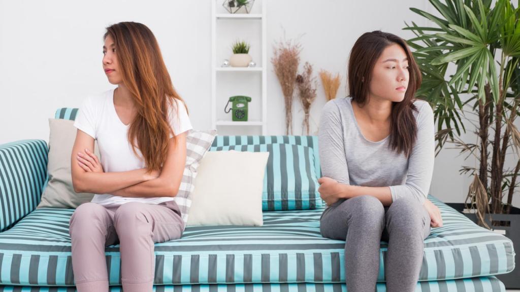 two women sitting on a couch