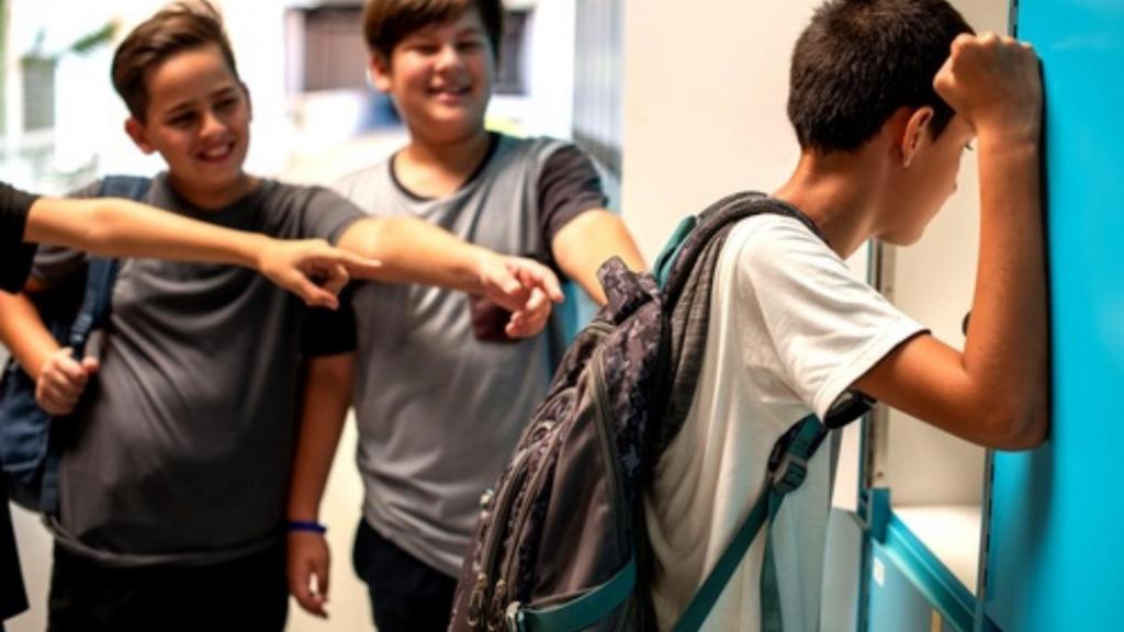 Kids pointing at another student