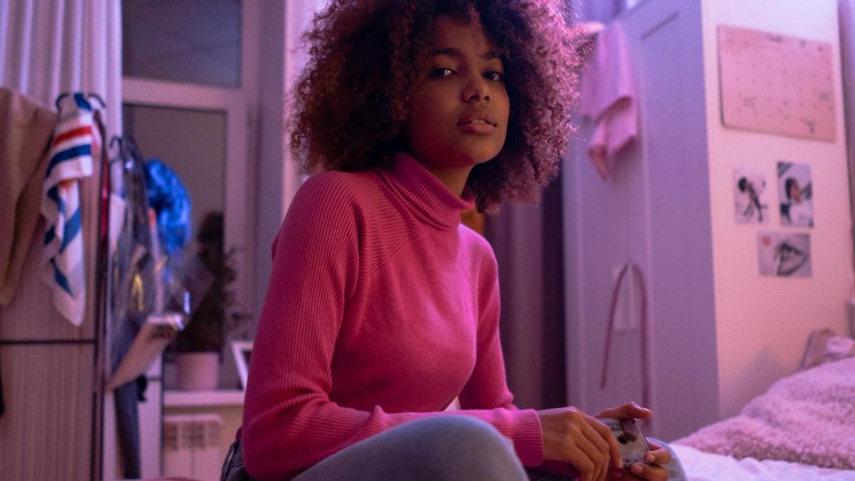 Her Bedroom Used To Be Her Safe Space, But Her Neighbors Late Night Guitar And Shouting Have Her Dreading Going Home teen girl in bedroom with moody lighting