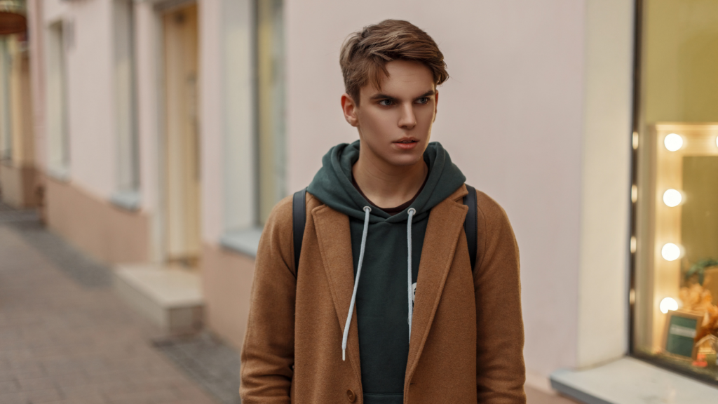 teenage boy walking along street