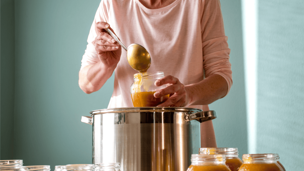 woman filling handmade jam jars