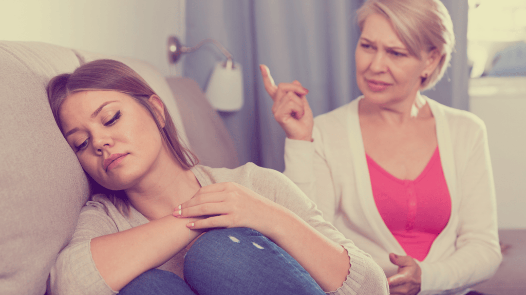 young woman rolling her eyes while her mom yells at her